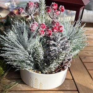 faux winter greenery in a pine tree ceramic bowl